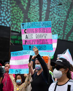 A sign at a rally seen that says transgender chlidren are not political pawns.