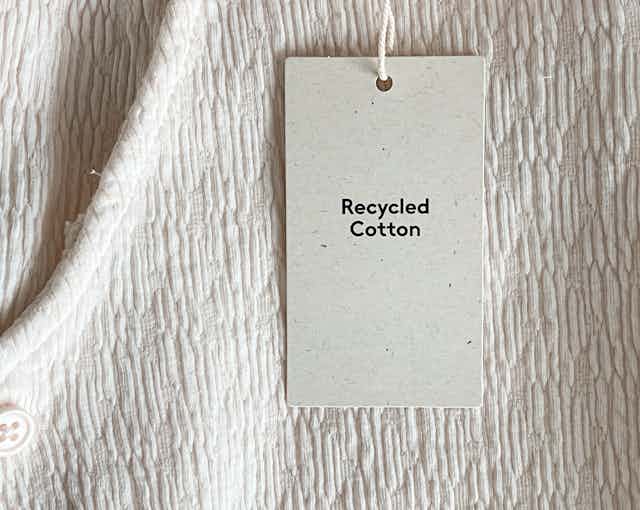 A white garment tag reads "Recycled Cotton", 