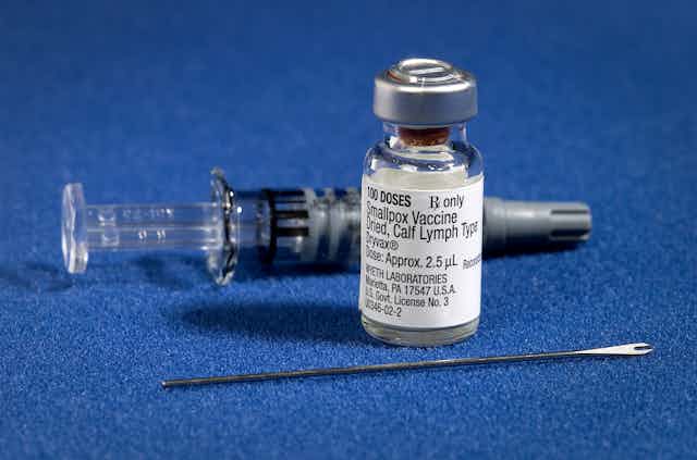 Smallpox vaccine with bifurcated needle