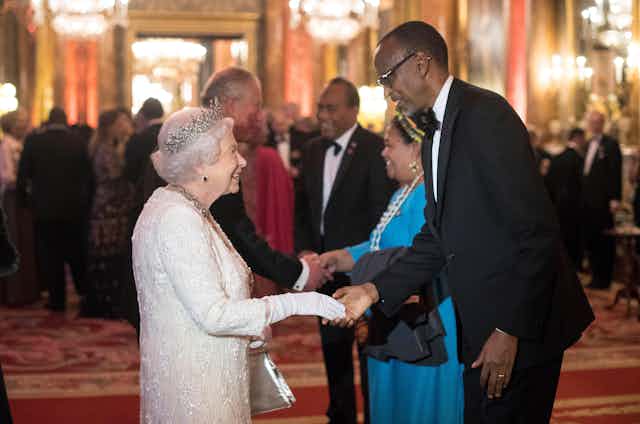 Queen Elizabeth II greets Paul Kagame, President of Rwanda, in the Blue Drawing Room at Buckingham Palace in London during the CHOGM meeting in 2018.