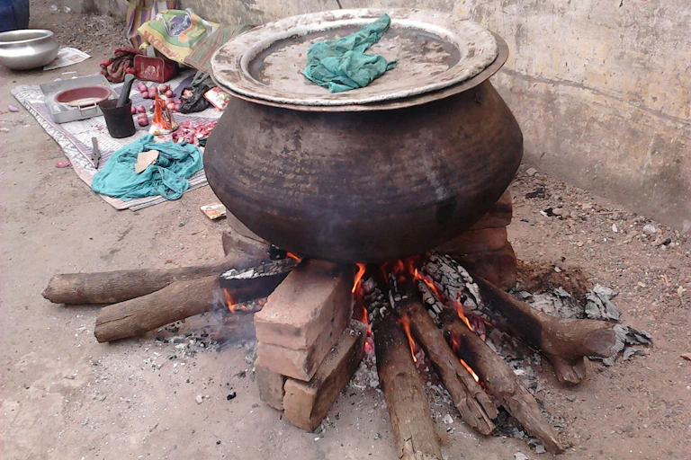 Large pot on top of firewood