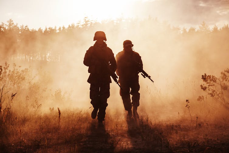 Two soldiers in a sandy haze.
