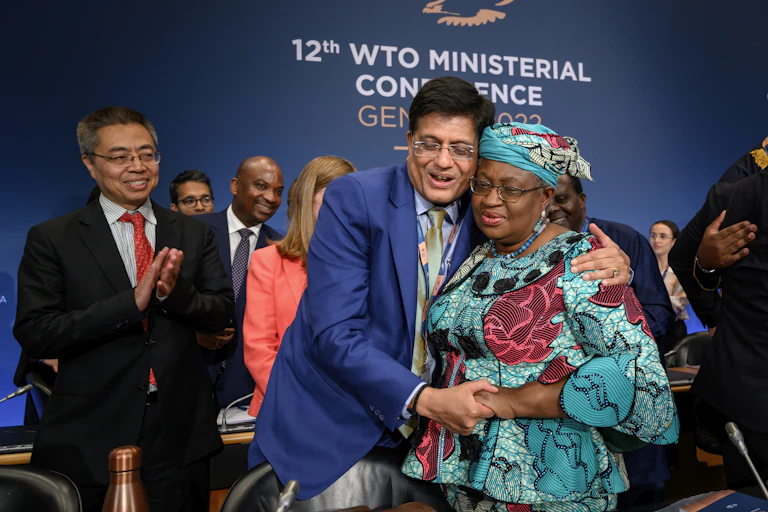 World Trade Organization director-general Ngozi Okonjo-Iweala, right, is congratulated by India's minister of commerce Piyush Goyal at the end of the WTO Ministerial Conference on June 17 2022.