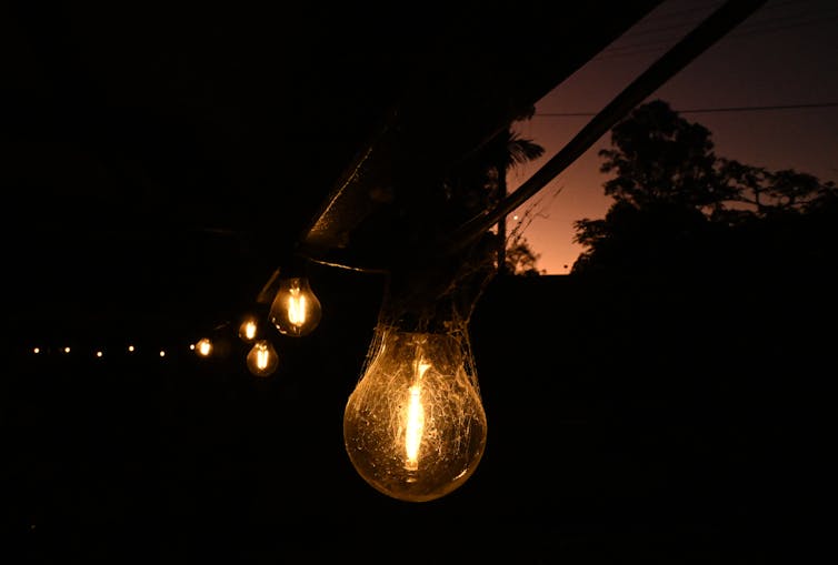 string of light bulbs in dark