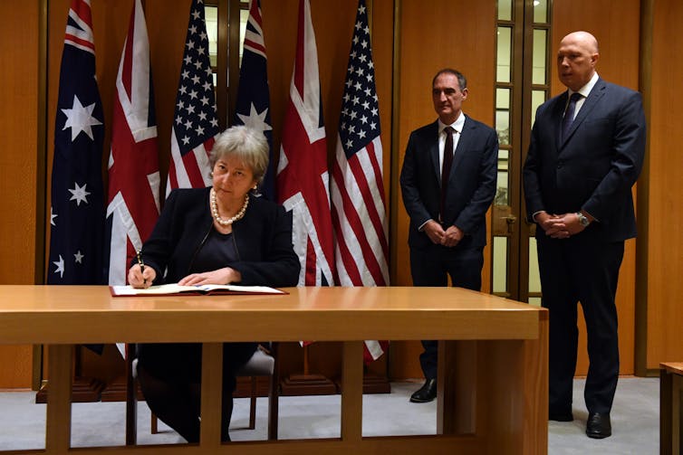 United Kingdom High Commissioner Victoria Treadell, Minister for Defence Peter Dutton and United States Chargé d’Affaires Michael Goldman at the signing of an AUKUS agreement at Parliament House in Canberra