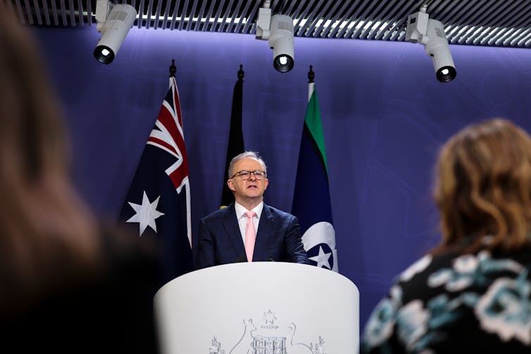 Standing at a podium, Australian Prime Minister Anthony Albanese speaks to the media during a press conference