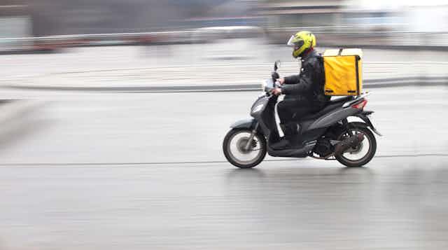 Delivery rider on motor scooter