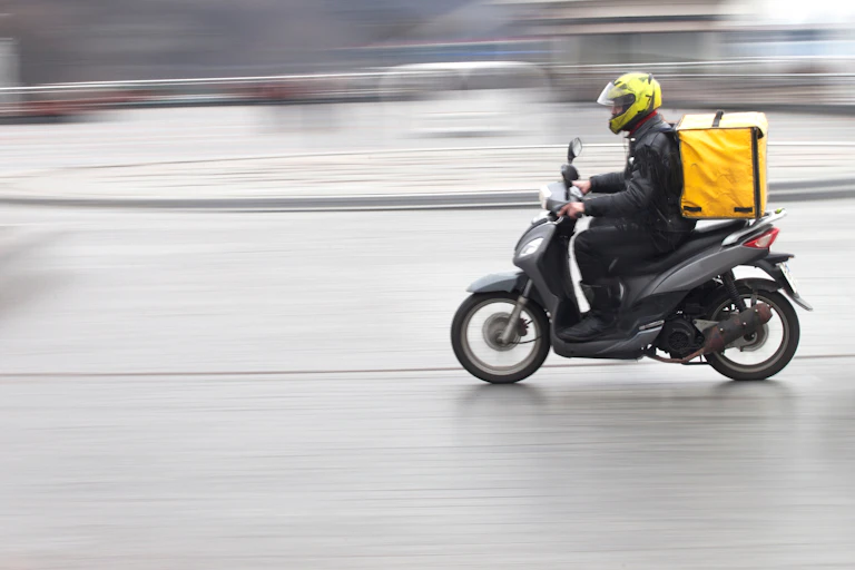 Delivery rider on motor scooter