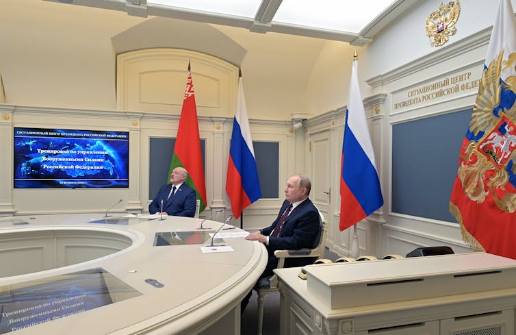Vladimir Putin and Aleksander Lukashenko watch a video screen as part of an exercise to test Russia's strategic deterrent, Moscow February 2022.