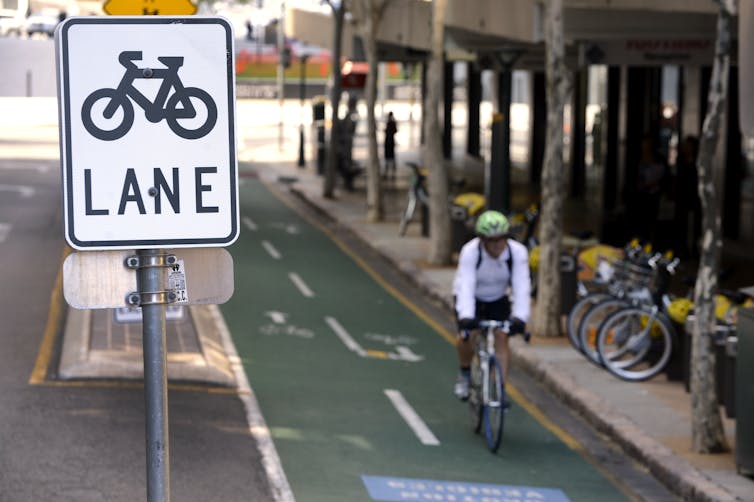 A cyclist rides his bike on a bike lane