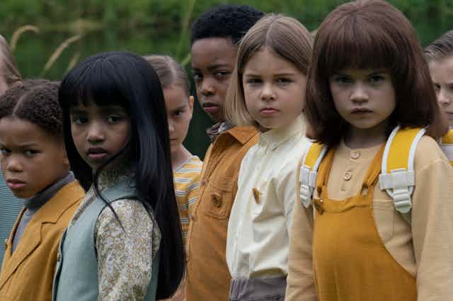 A group of children stare.