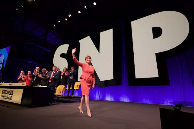 Nicola Sturgeon striding across the stage at the SNP conference 2018.