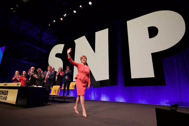 Nicola Sturgeon striding across the stage at the SNP conference 2018.