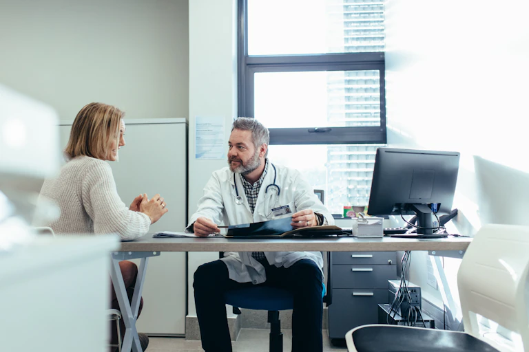 A woman sees a doctor.