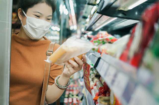 Woman looks at food packaging