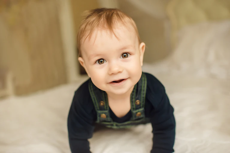 8 month-old child crawling towards you