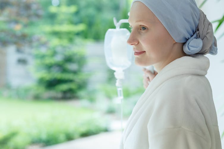 Woman in headscarfe holding a drip