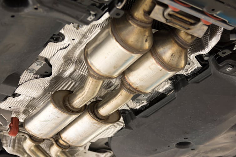 A series of metal chambers and pipes on the underside of a car.