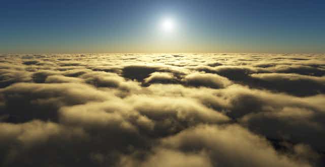 A white sun hangs over a thick layer of yellow-white clouds.