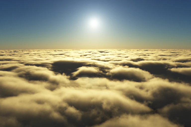 A white sun hangs over a thick layer of yellow-white clouds.