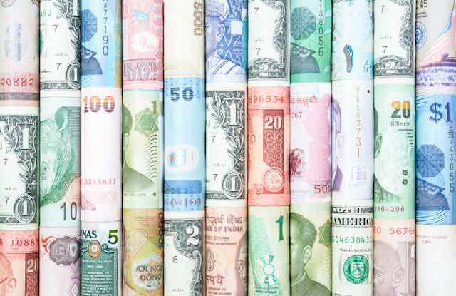 rolled up monetary bills from across the world