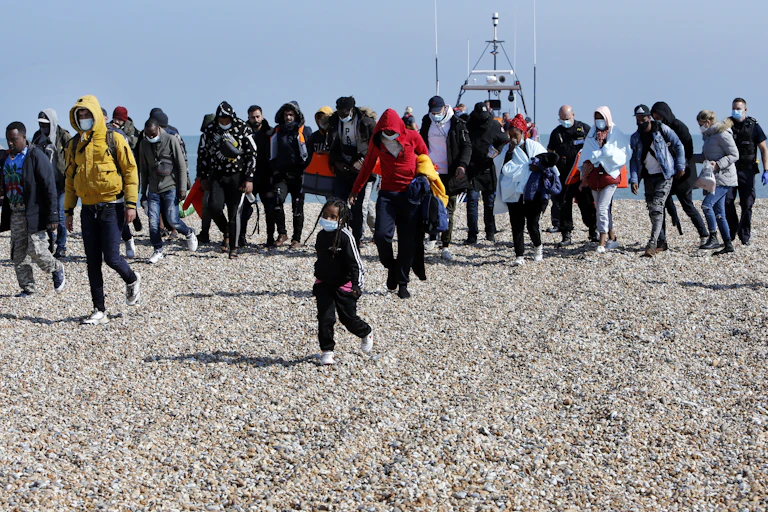 A group of Channel-crossing migrants who have arrived on a Kent beach.
