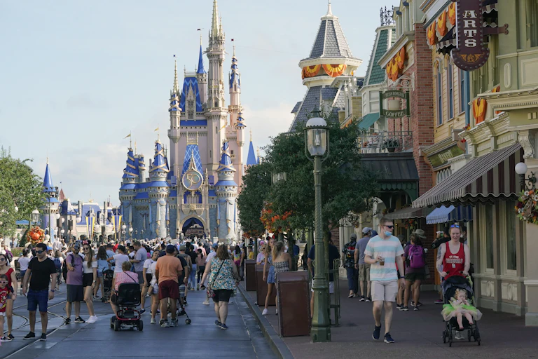 The Magic Kingdom at Disney is pictured with visitors in the forground
