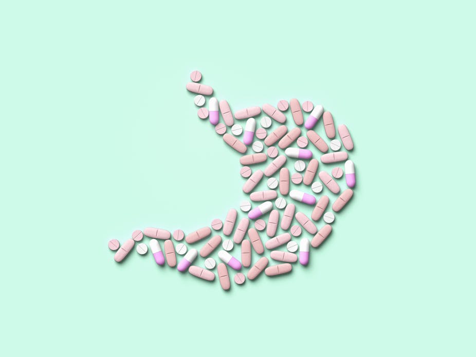 Illustration of pills displayed in the shape of a stomach