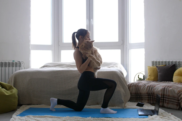 Woman doing yoga with cat
