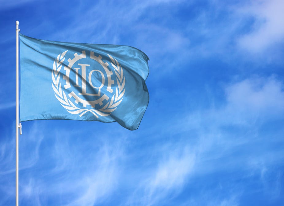Blue ILO flag on a flagpole, blue sky background