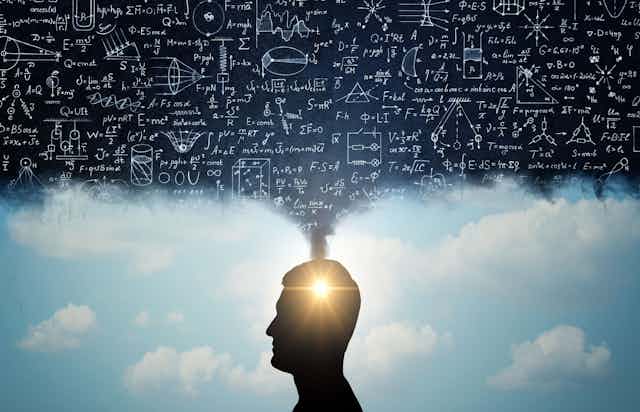 Silhouette of a man, with thoughts in the form of physico-mathematical formulas.