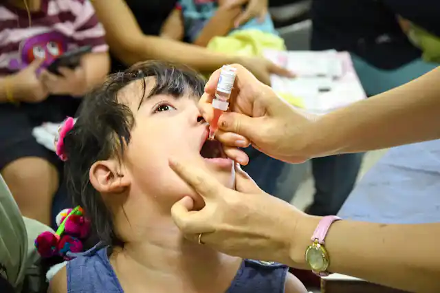 Child receiving oral polio vaccine