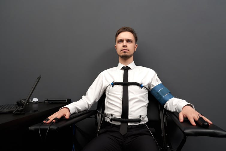 Man taking a lie detector test.