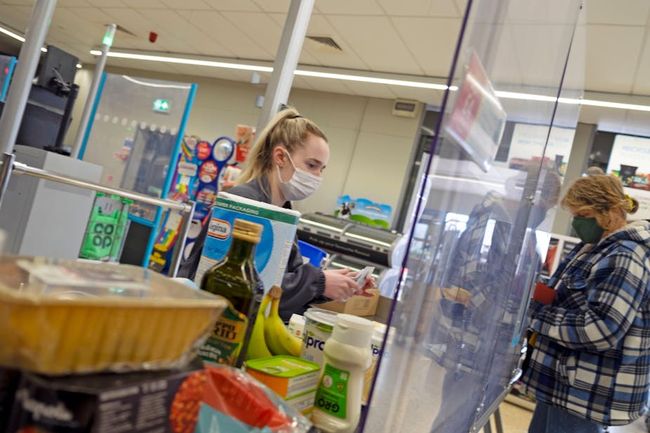 Woman at Coop checkout in Wales