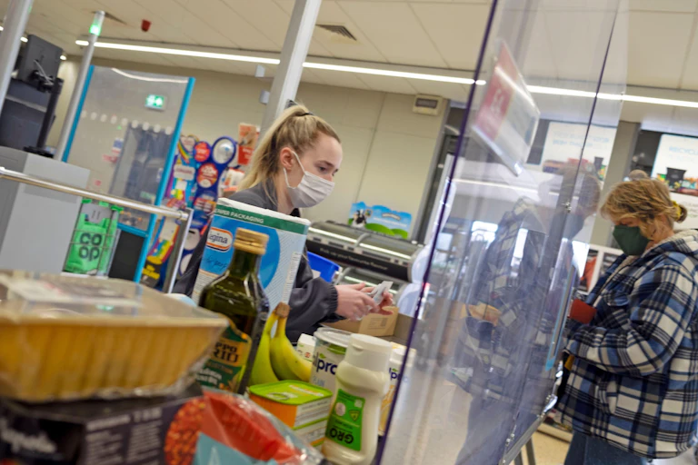 Woman at Coop checkout in Wales
