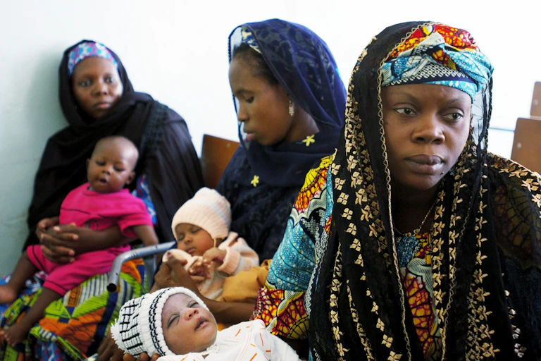 Mothers wait to have their children immunized against a series of diseases in Kano, Nigeria