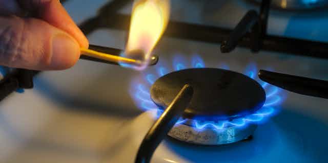 Lighting stovetop gas burner with match
