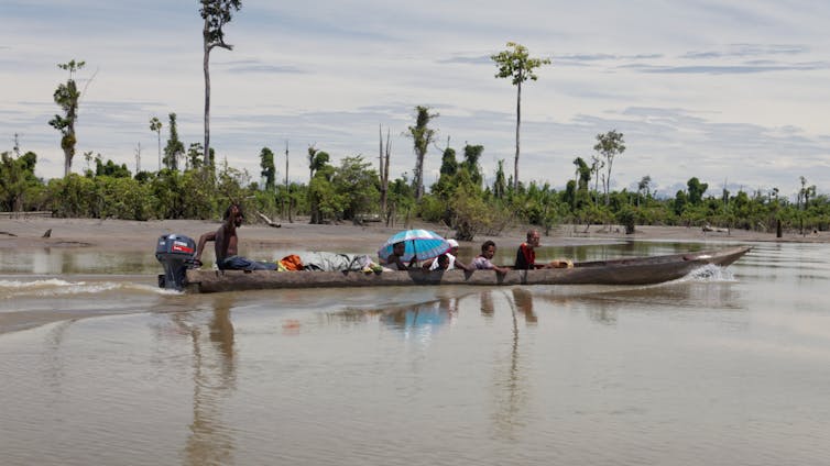 people in boat on grey river