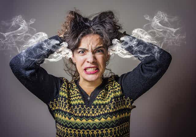 Image of a frustrated woman literally steaming with rage
