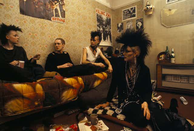 A group of punks in a bedroom.