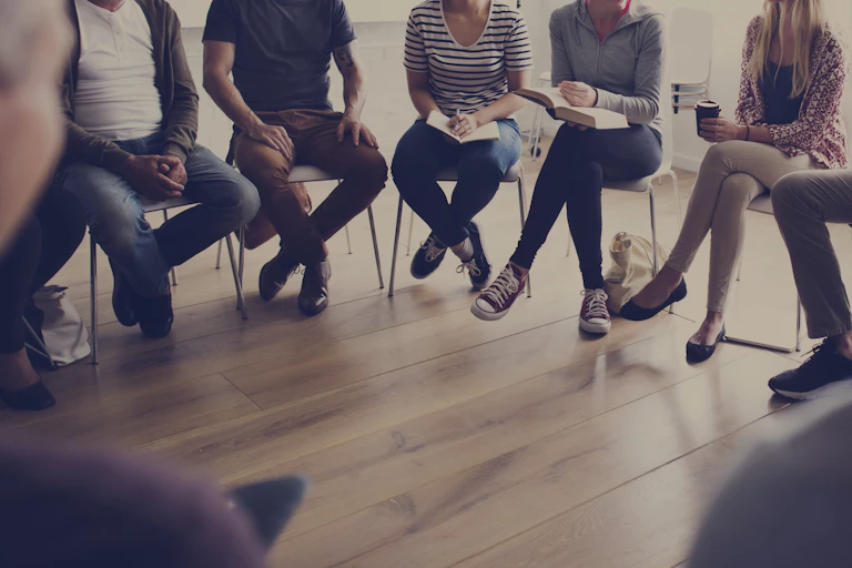 A group of people sit in a circle