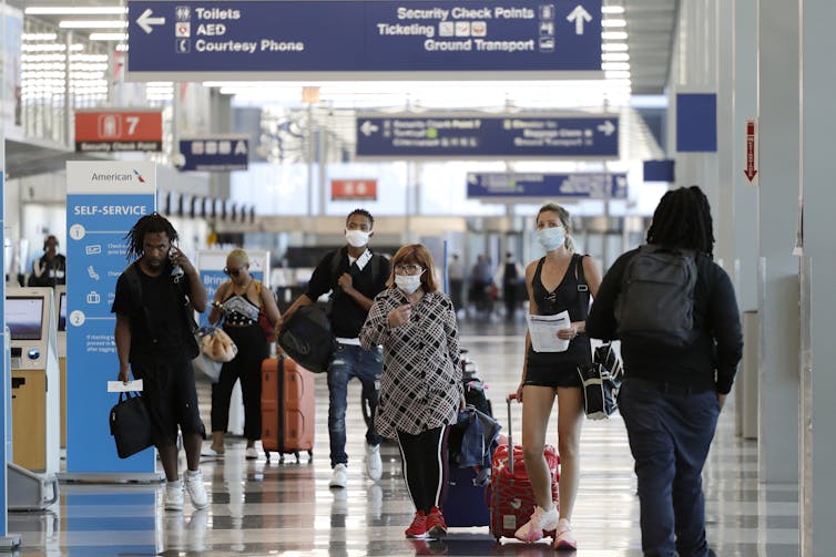 People walking through an airport