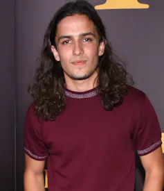 A young man smiling.