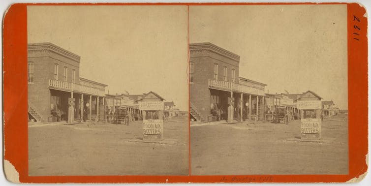 A view of Dodge City, Kansas, in 1878 including a sign banning firearms.