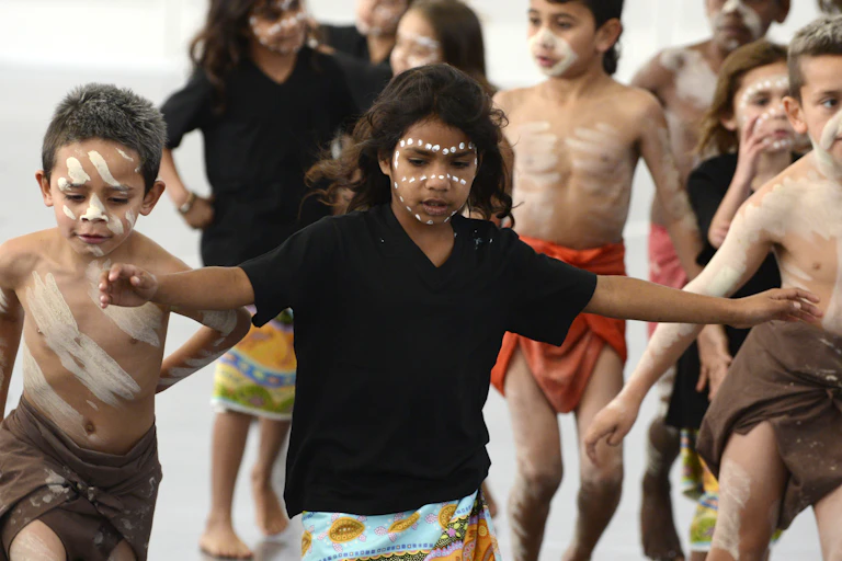 Some young Aboriginal children with paint on their faces.