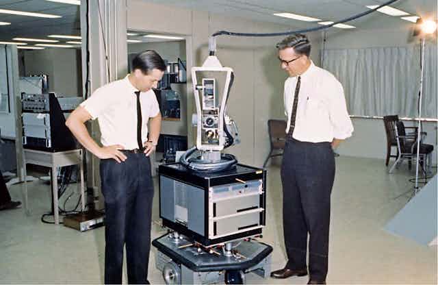 Two men with a machine