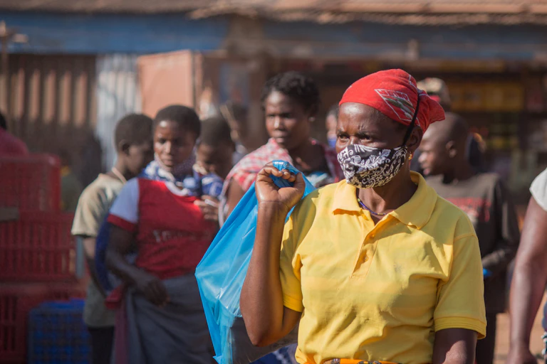 A woman wearing a mask walking in a market