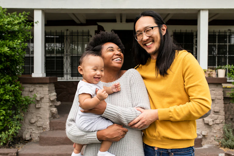 A multicultural family on a front porch.