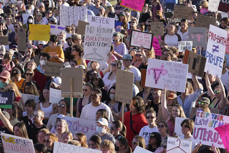 A crowd of people holding various anti-abortion signs
