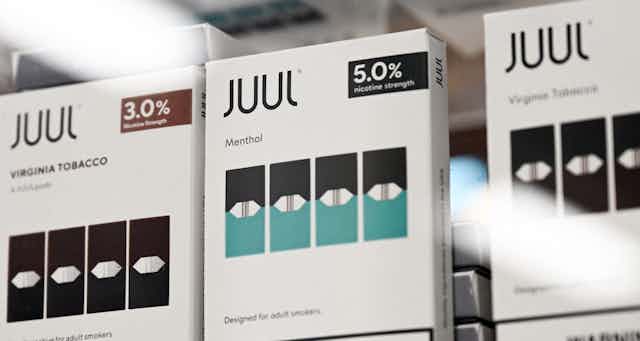 Three packs of Juul e-cigarettes.